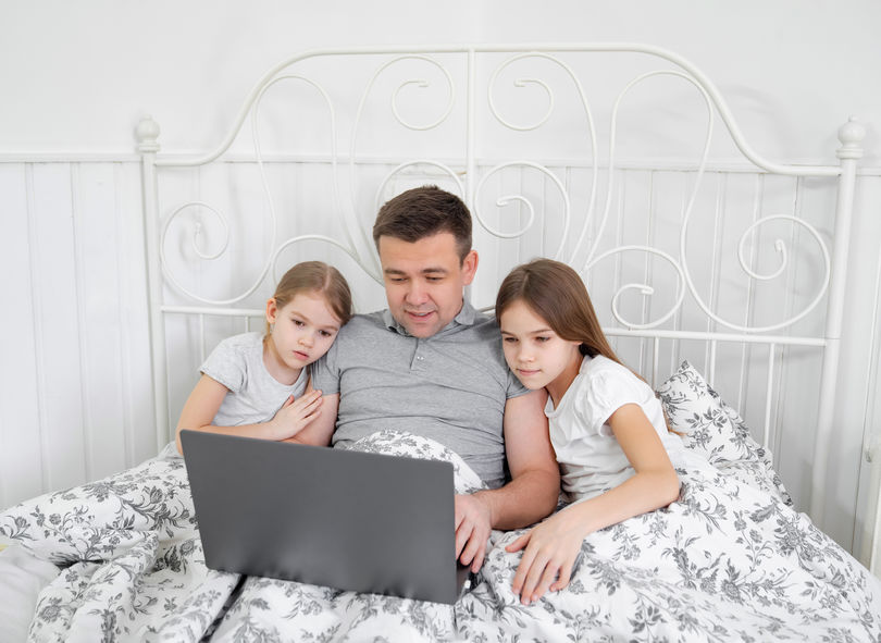 a dad with his daughters during quarantine working from home