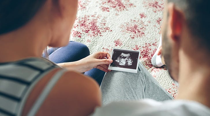 couple was looking at the baby in the ultrasound pic